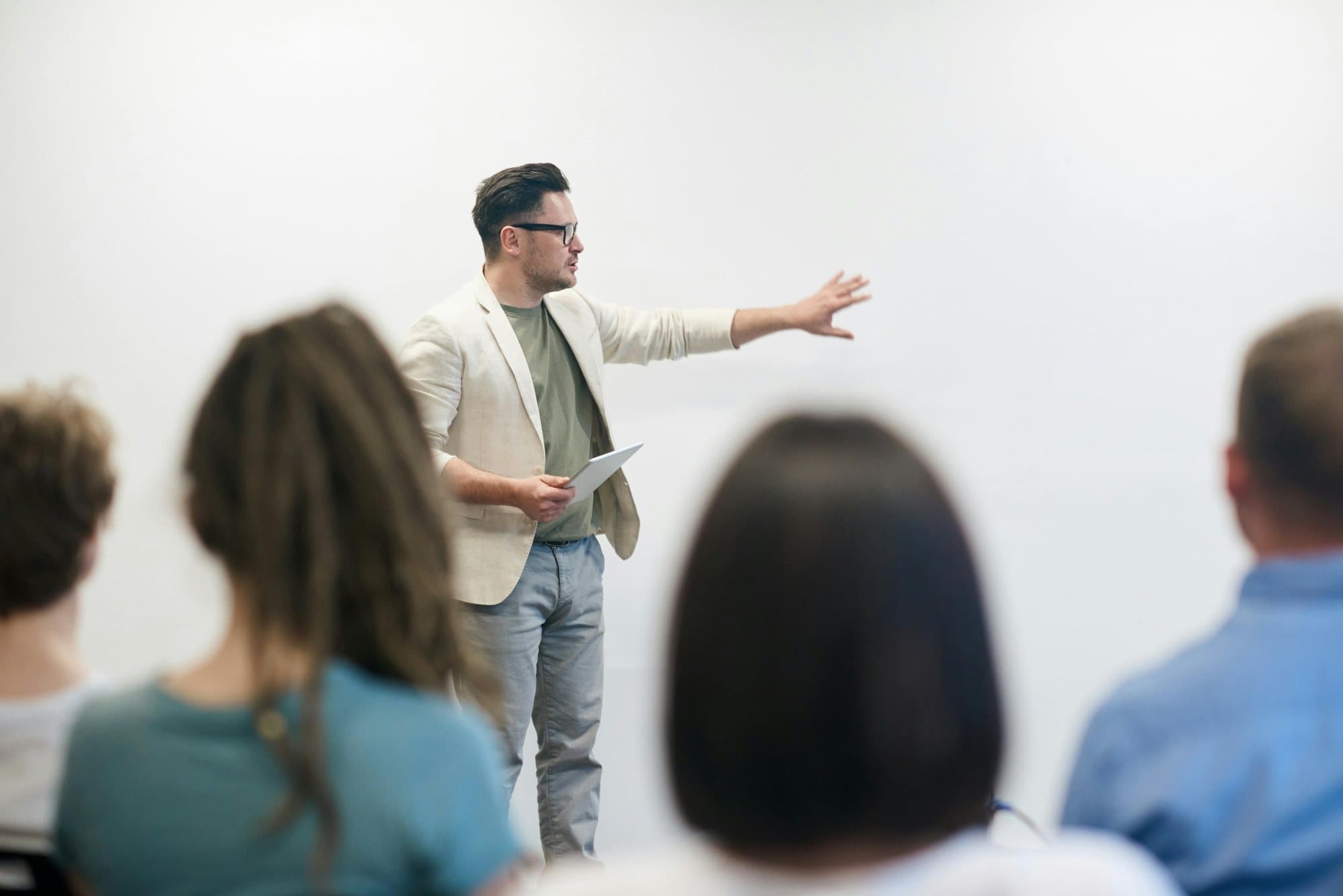 An instructor presenting to a small group in a training room