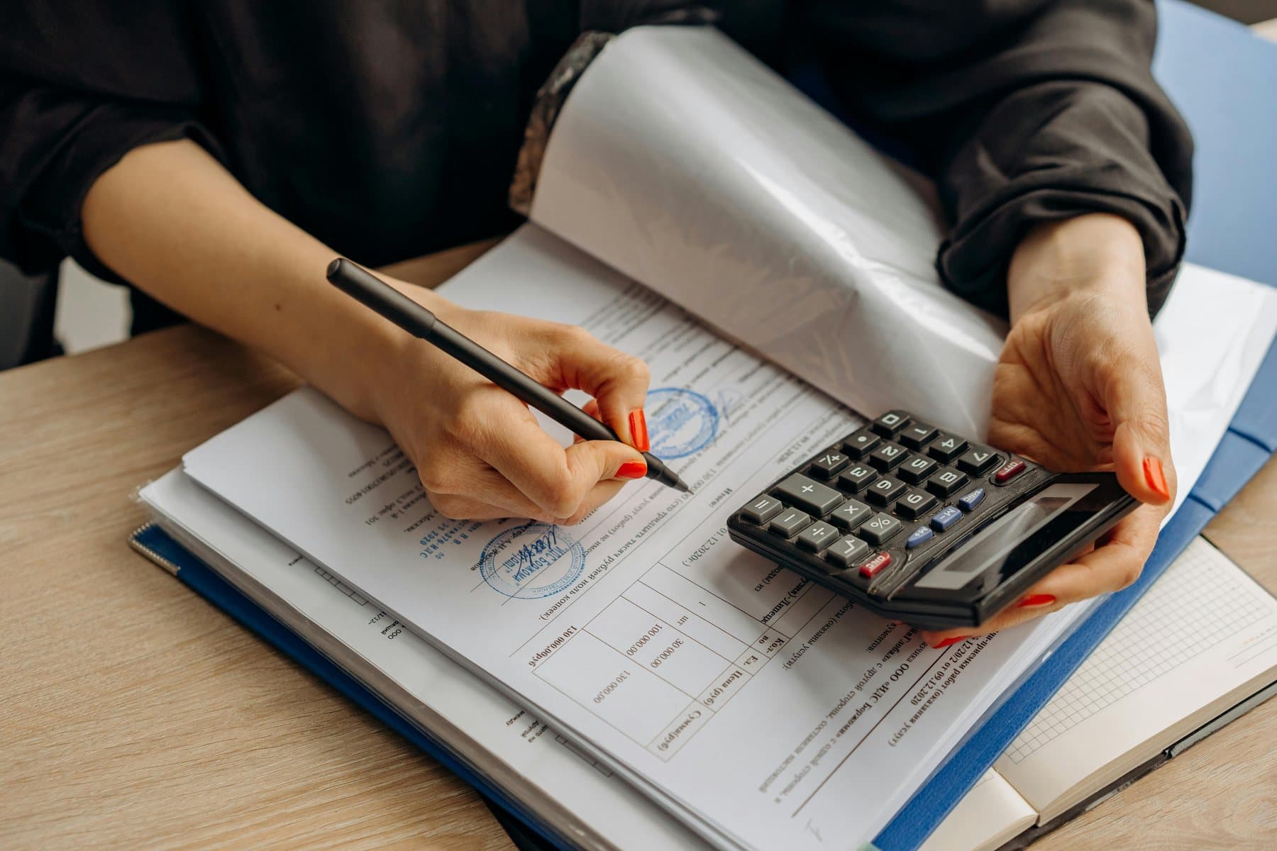 Costs being worked through on paper with a calculator