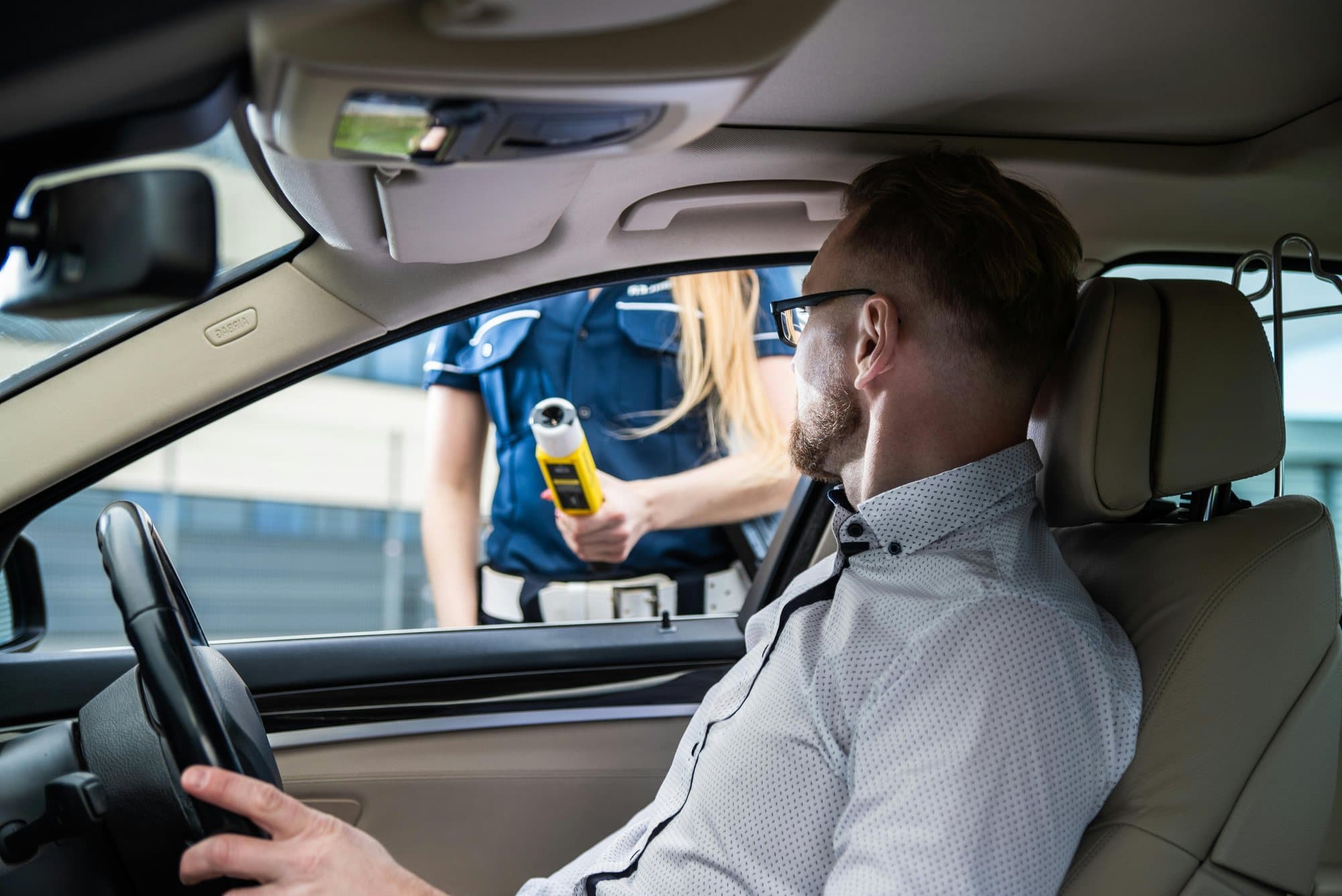 A company car driver at the wheel during an on-road check